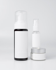 Blank white cosmetic skincare makeup containers.