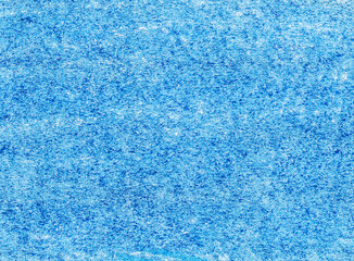 Texture of paper covered with blue crazon. Abstract background