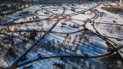 A winding bike path in a city park. City park in winter. Snow lies on the ground. Aerial...