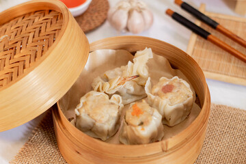 steamed four flavor dumpling dimsum in traditional bamboo steamer. Close up food photography
