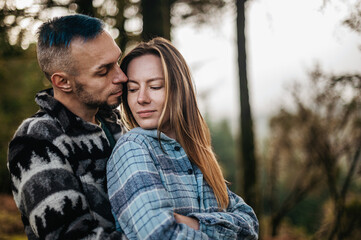 Couple embracing in an autumn park surrounded by the beauty of the fall season