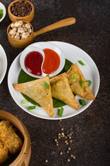 Crispy fried samosa filling of mashed potato, peas and spices with chili and tomato sauce.