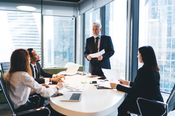 Group of diverse coworkers having conversation in office together