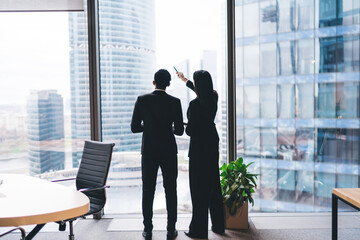Unrecognizable business partners discussing plan in modern office