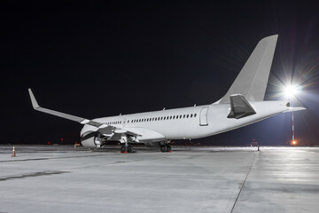 Modern passenger airliner on the night airport apron