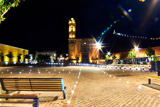 downtown in the night with church in the background, lights on the ground, hidalgo del parral chihuahua 