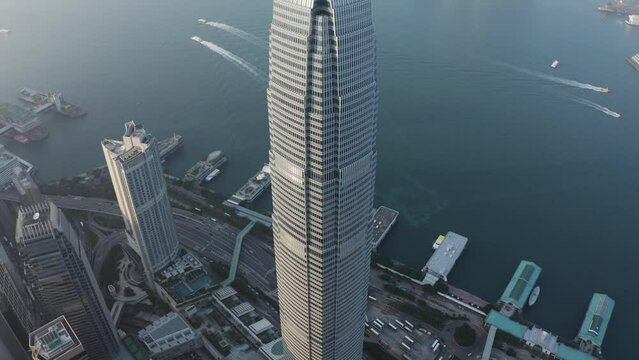 Aerial view of IFC Tower and skyline in Hong Kong during sunset.