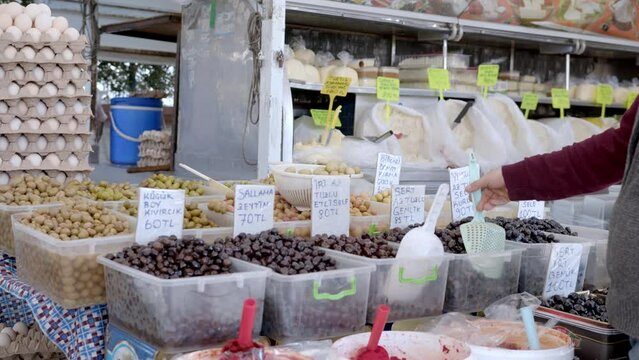 Open air market. People in bazaar choose products. A lot of people go shopping, a lot of different vegetables and fruits. Fethiye, Turkiye- January 05, 2023.