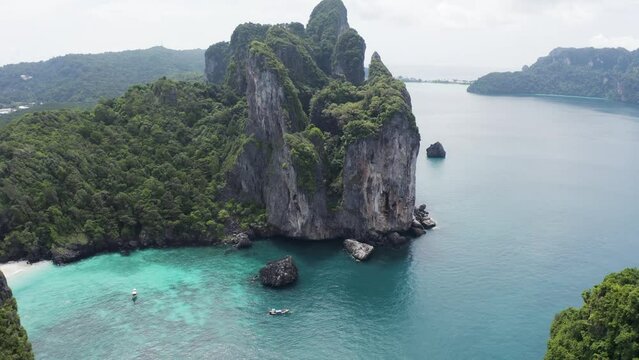 Aerial view of Loh Lana Bay and Nui Beach with high cliffs on Phi Phi island, Thailand.