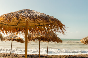 Fototapeta na wymiar straw umbrella on the beach