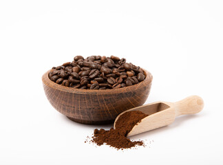 Bowl of ground coffee and beans isolated on white background. Coffee in wooden spoons.