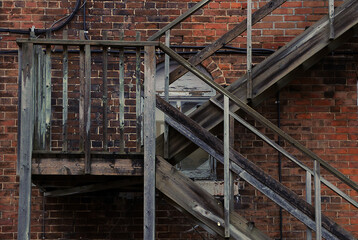 OLD  WOODEN FIRE ESCAPE ON BRICK BUILDING