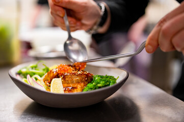 chef hand cooking donburi food in the restaurant kitchen