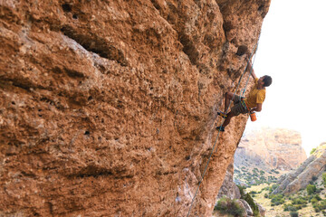 climber climbs the wall. a man is engaged in sport climbing.