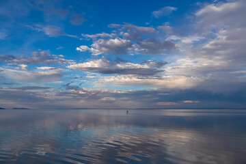 Scenic view of beautiful water reflections in lake of Bonneville Salt Flats at sunset, Wendover, Western Utah, USA, America. Dreamy clouds mirroring on the water surface creating romantic atmosphere