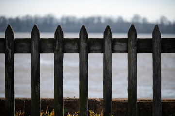 Weathered picket fence by the river