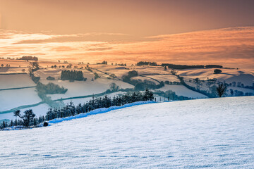 A winter sunset in the snow covered Brecon Beacons.