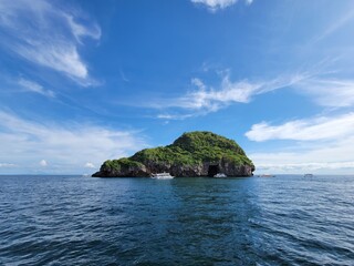 Fototapeta na wymiar Traditional Fishing Boats by Tiny Tropical Island in Philippines