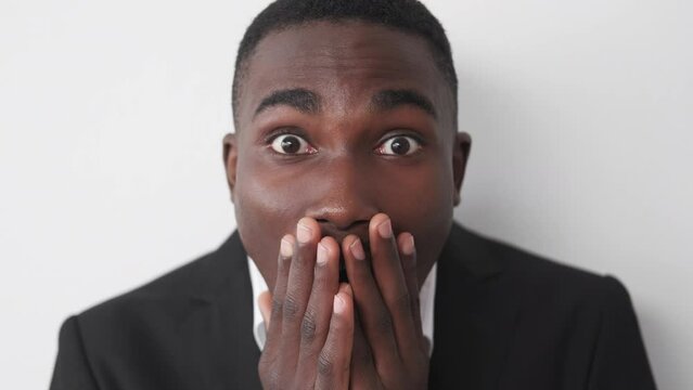 Shock news. Embarrassed businessman. Work mistake. Portrait of surprised man feeling afraid of job trouble posing on white studio background.
