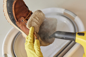 washing the dirty cleaning the shoes with a steam cleaner.