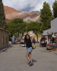 Woman walking in a small town near the mountains