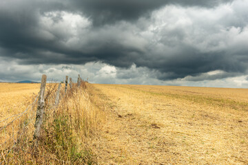 Countryside landscape under threatening sky.