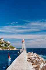 Fototapeta na wymiar Lighthouse a the end of breakwater in Nice, France.
