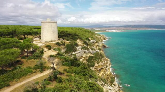 Aerial view of the cliffs near Torre del Tajo watchtower and hiking trail on the coastline of Barbate, Andaluc&iacute;a, Spain.