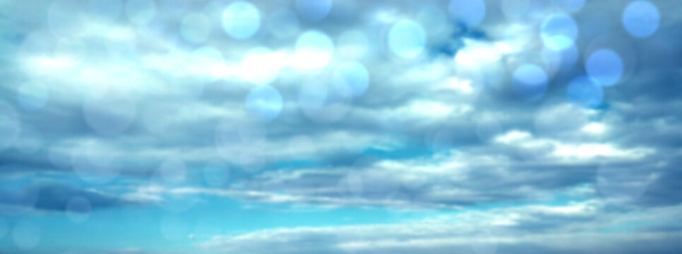 Shiny blue background with sparkles, lights and bokeh. Atmospheric background for a holiday, business, disco. Banner.