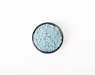 Blue spirulina powder in bowls isolated on white background. Natural vegan superfood. Food supplement. Phycocyanin extract.