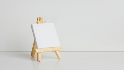 Mini painting on an easel on a light background. at an angle