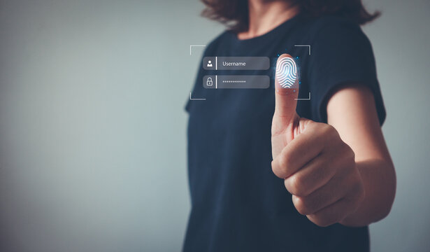 Businesswoman thumbs up with virtual fingerprint to scan biometric identity. Fingerprint scanning, biometric authentication, cybersecurity, fingerprint password. technology against digital cybercrime.