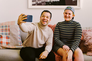 Trans friends taking selfie with phone