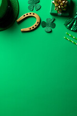 Plakat Image of green hat, clover, horse shoe and copy space on green background