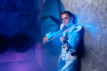 Fototapeta premium Side view portrait of beautiful fashion woman violinist