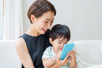 スマートフォンで遊ぶ子供とお母さん