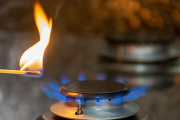 A match sets fire to a gas stove