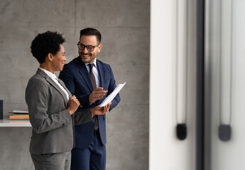 Business partner standing talking about new project