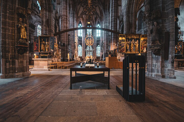 Majestic altar in the middle of the hall of the ancient Gothic Catholic Cathedral of Nuremberg, Germany