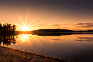 Peaceful landscape of Lake Inari with the midnight sun in Lapland, Finland - obrazy, fototapety, plakaty