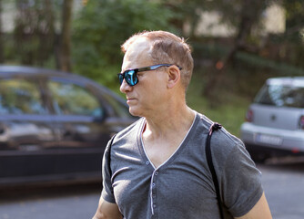 attractive middle aged man walking in the park