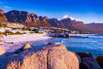 view of mountains and beach in camps bay, cape town, south africa at sunset