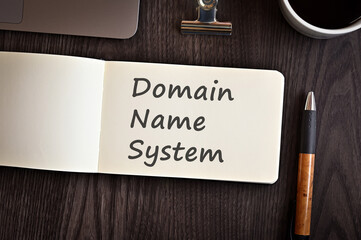 There is notebook with the word Domain Name System. It is an eye-catching image.