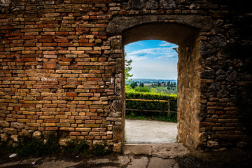 view of tuscany through city walls in italy
