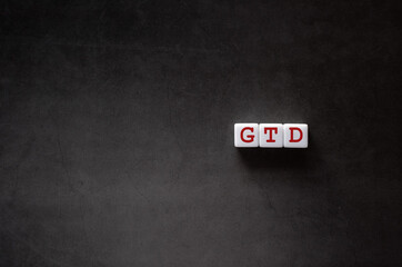 There is white cube with the word GTD. It is an abbreviation for Getting Things Done as eye-catching image.