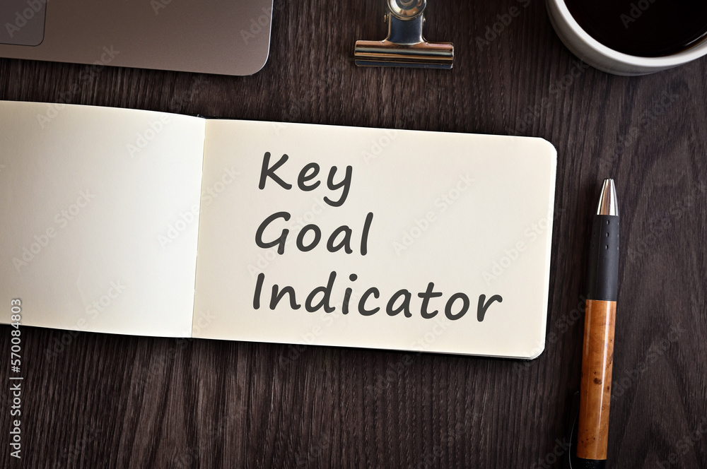 Poster there is notebook with the word key goal indicator. it is an eye-catching image.