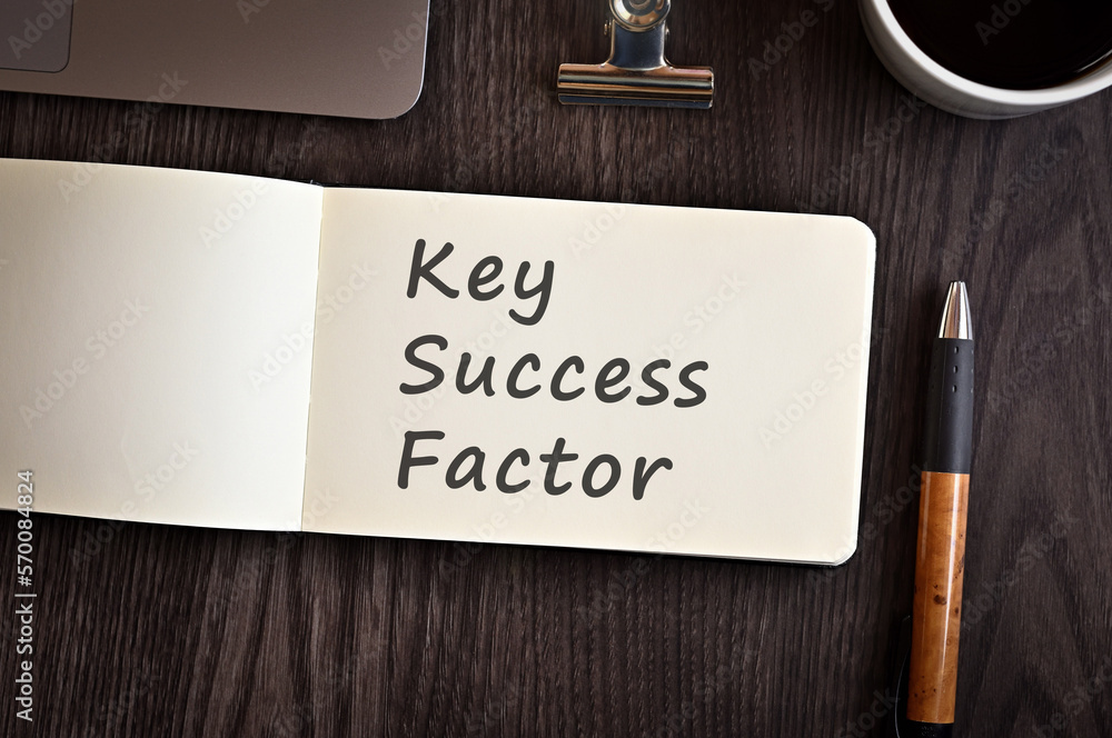 Poster there is notebook with the word key success factor. it is an eye-catching image.