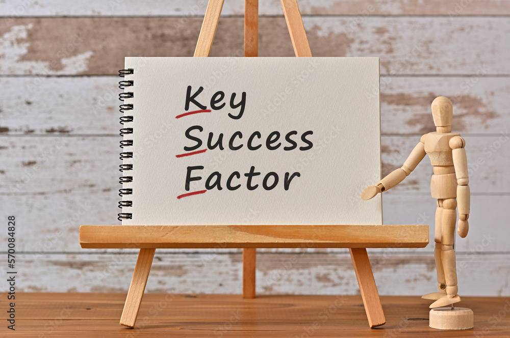 Poster there is notebook with the word key success factor. it is an eye-catching image.