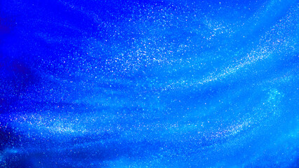 Abstract blue background with tints of silver sparkles. Liquid glitter background with small glowing particles. Blue flowing waves textured background with white streaks.