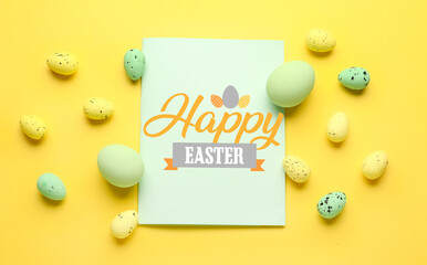 Easter greeting card and painted eggs on yellow background